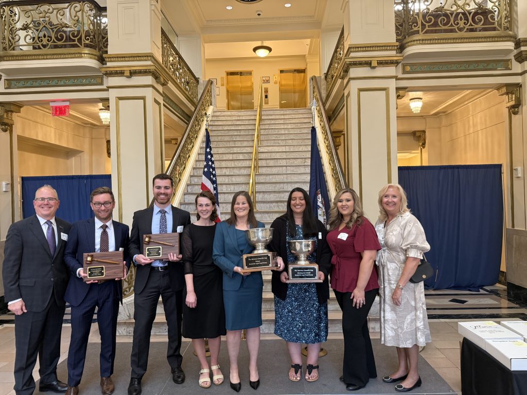 7 people in a group photo. 4 winners with their trophies and members of Feeding Southwest Virginia.